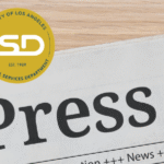 Newspaper with ISD logo and Press release title.